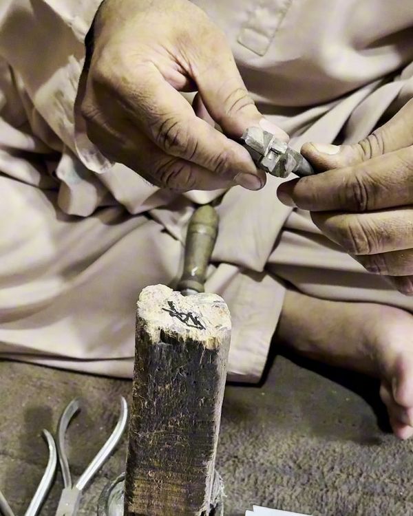 A Mubarra Instrumed craftsman filing the joint of an orthodontic plier by hand