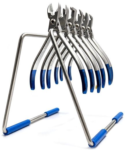 Six orthodontic cutters with blue-coated handles hanging on a stainless steel plier stand